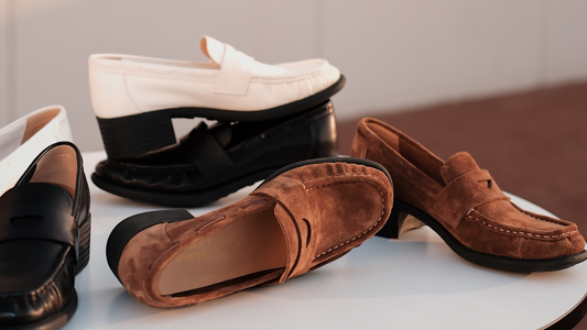 A bunch of leather loafer heels scattering on a white smooth table
