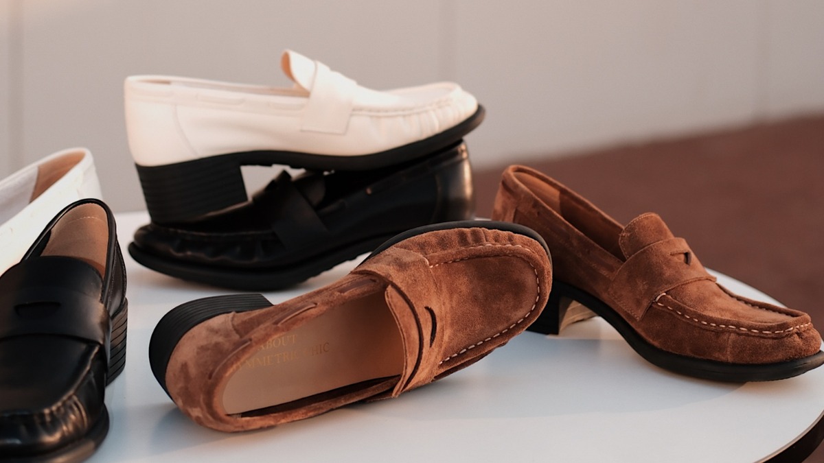 A bunch of leather loafer heels scattering on a white smooth table