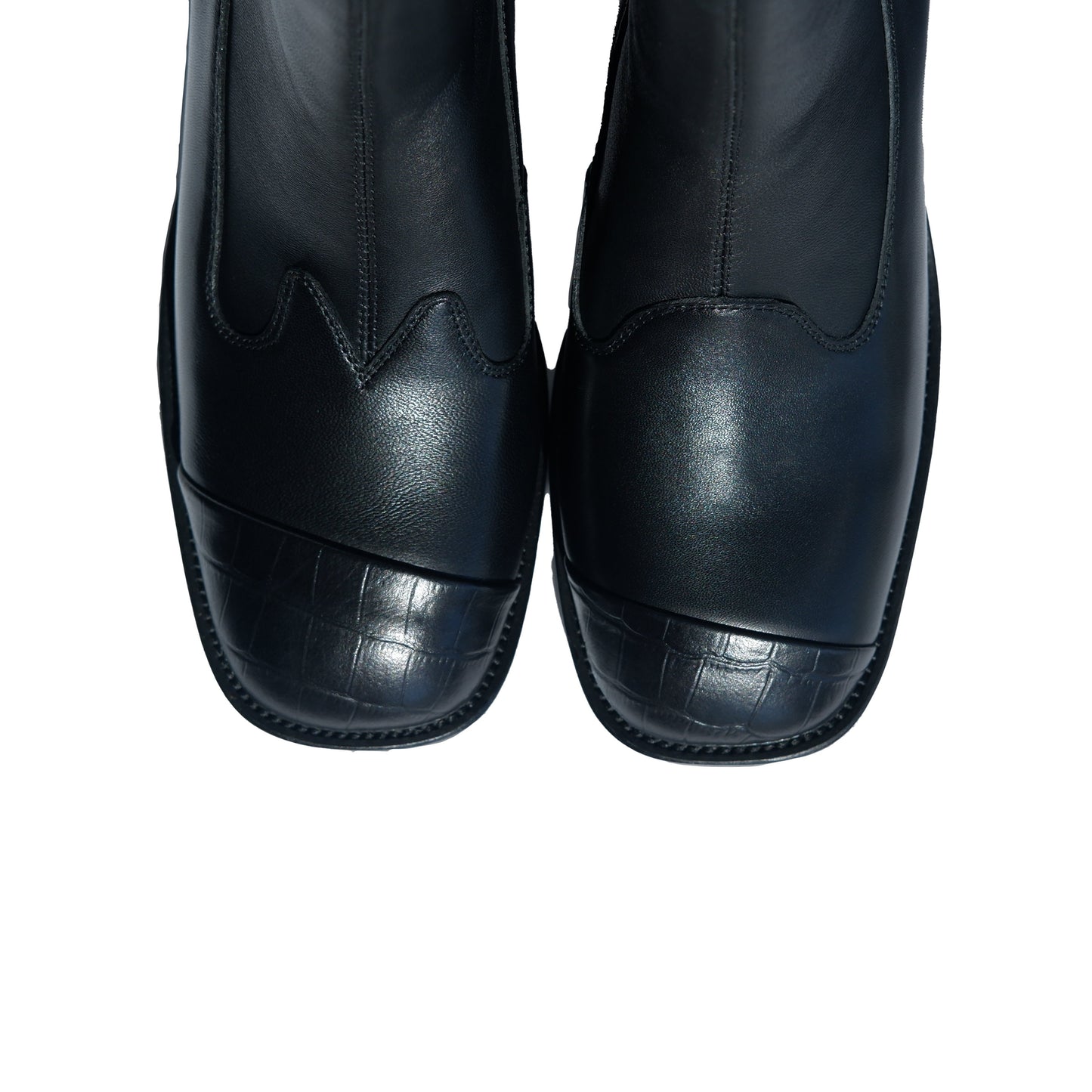 Top view of a pair of women's black leather square-toe ankle boots with block heels