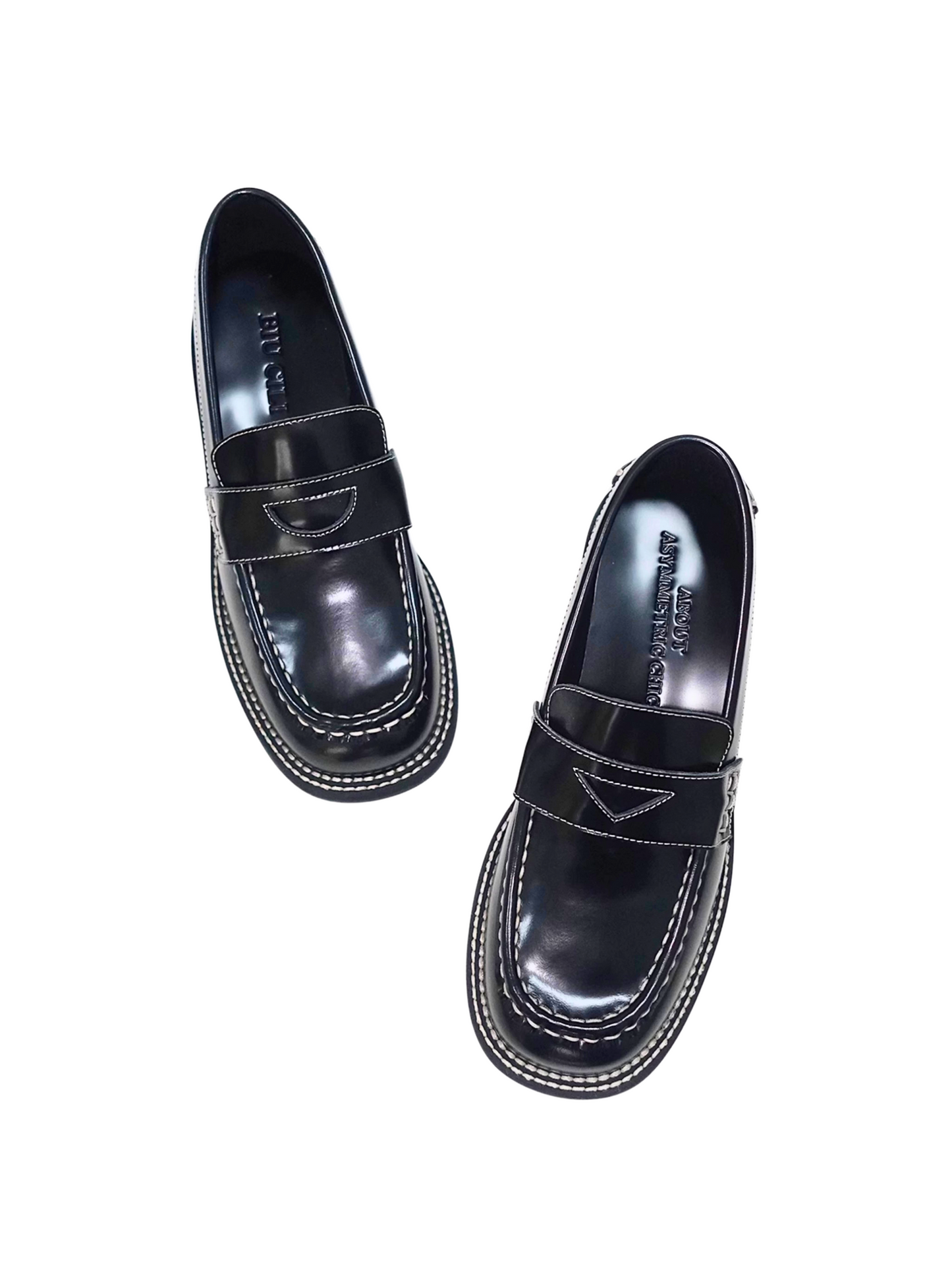 A pair of black leather loafer heels with asymmetric details for women