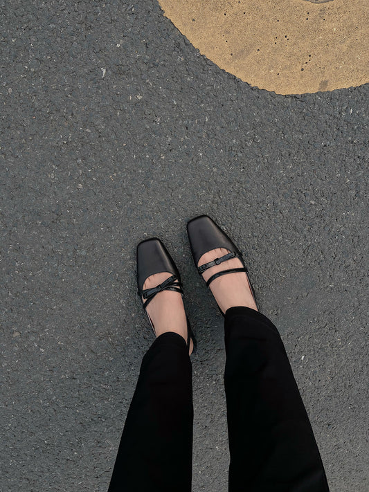 Wearing Black square toe Mary Jane shoes with asymmetric bow and low block heel, photographed on the street