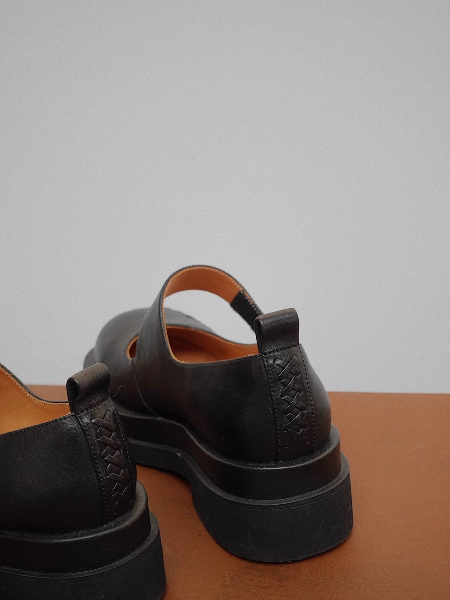 Black platform Mary Jane shoes with wide strap and low block heel, displayed on floor