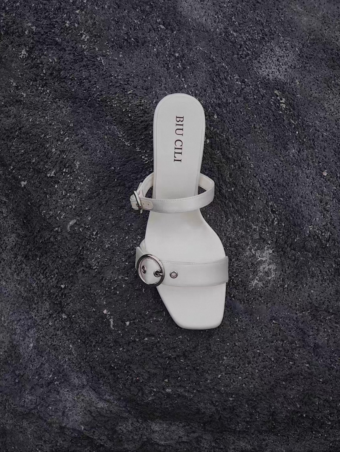 A mid heel sandal with two thick white silk straps and shiny silver buckle - top view