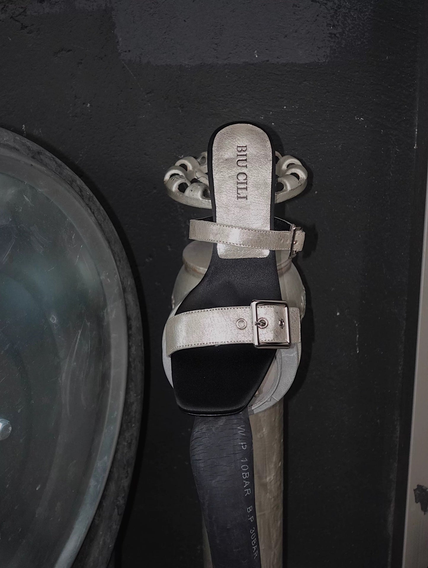 A mid heel sandal with two thick leather straps and shiny silver buckle - top view