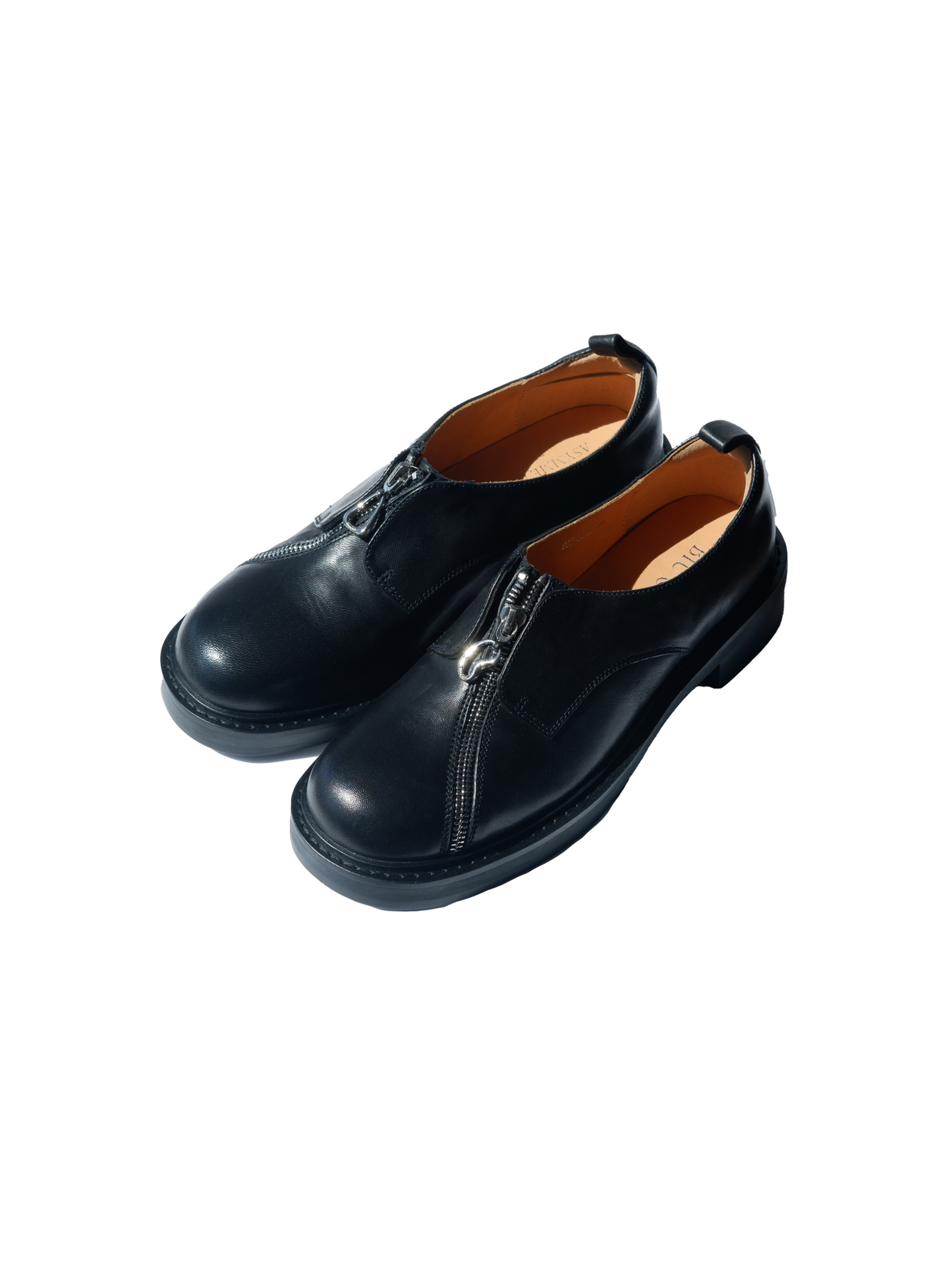 Black asymmetric leather loafers with curved zipper detail and rounded toe