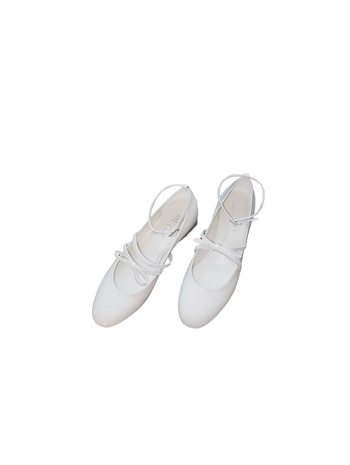 White patent leather Mary Jane heels with asymmetric bow straps