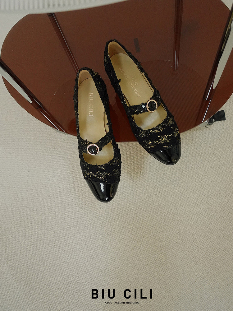 Elegant black Mary Janes featuring patent leather tweed design with asymmetric details for a modern touch.