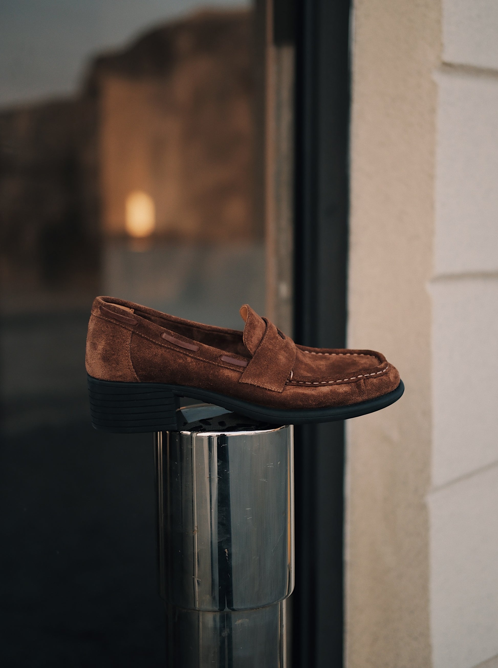 Women's brown suede mid-heel loafers with asymmetric detail on a platform
