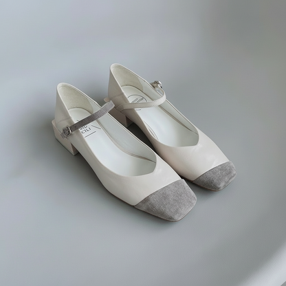 Pair of white shoes with gray accents on a light gray background