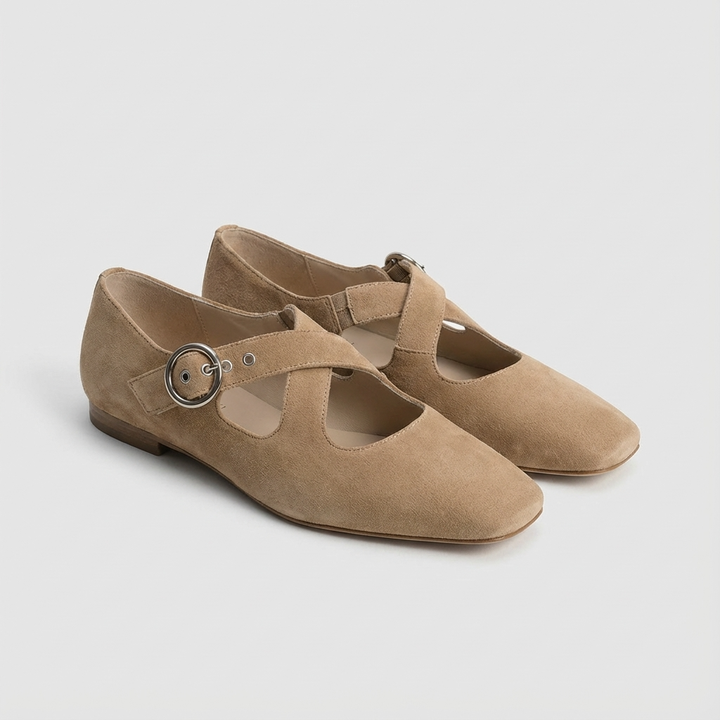 Pair of khaki suede shoes with a round buckle on a light gray background