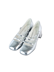 Metallic silver Mary Jane heels with triple asymmetric straps and block heel.