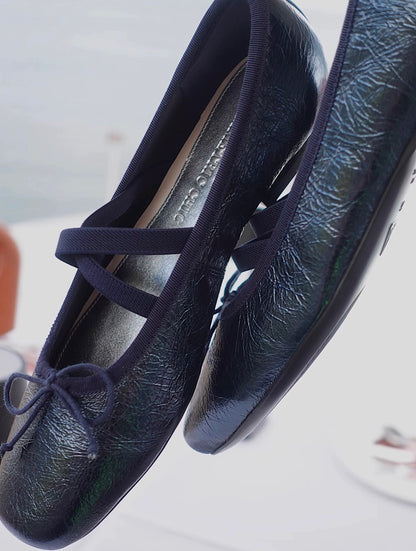 Side view of navy metallic leather Mary Jane ballet flats with asymmetrical cross straps