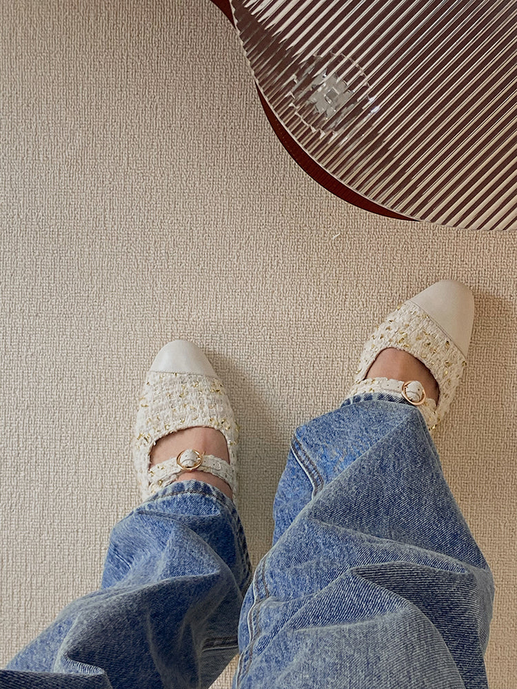 Stylish white Mary Janes featuring leather tweed design with asymmetric details for a modern touch.