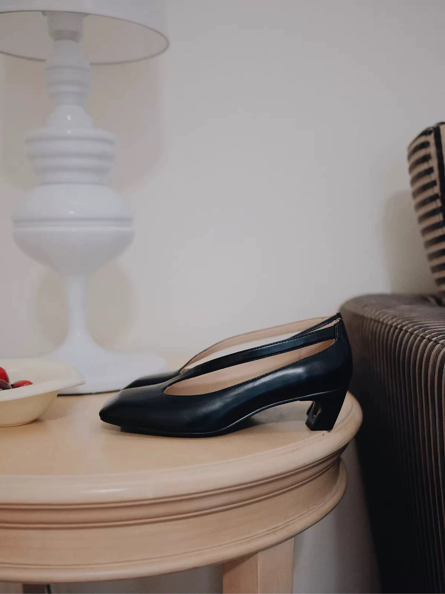 Black shoes on a wooden table with a blurred background