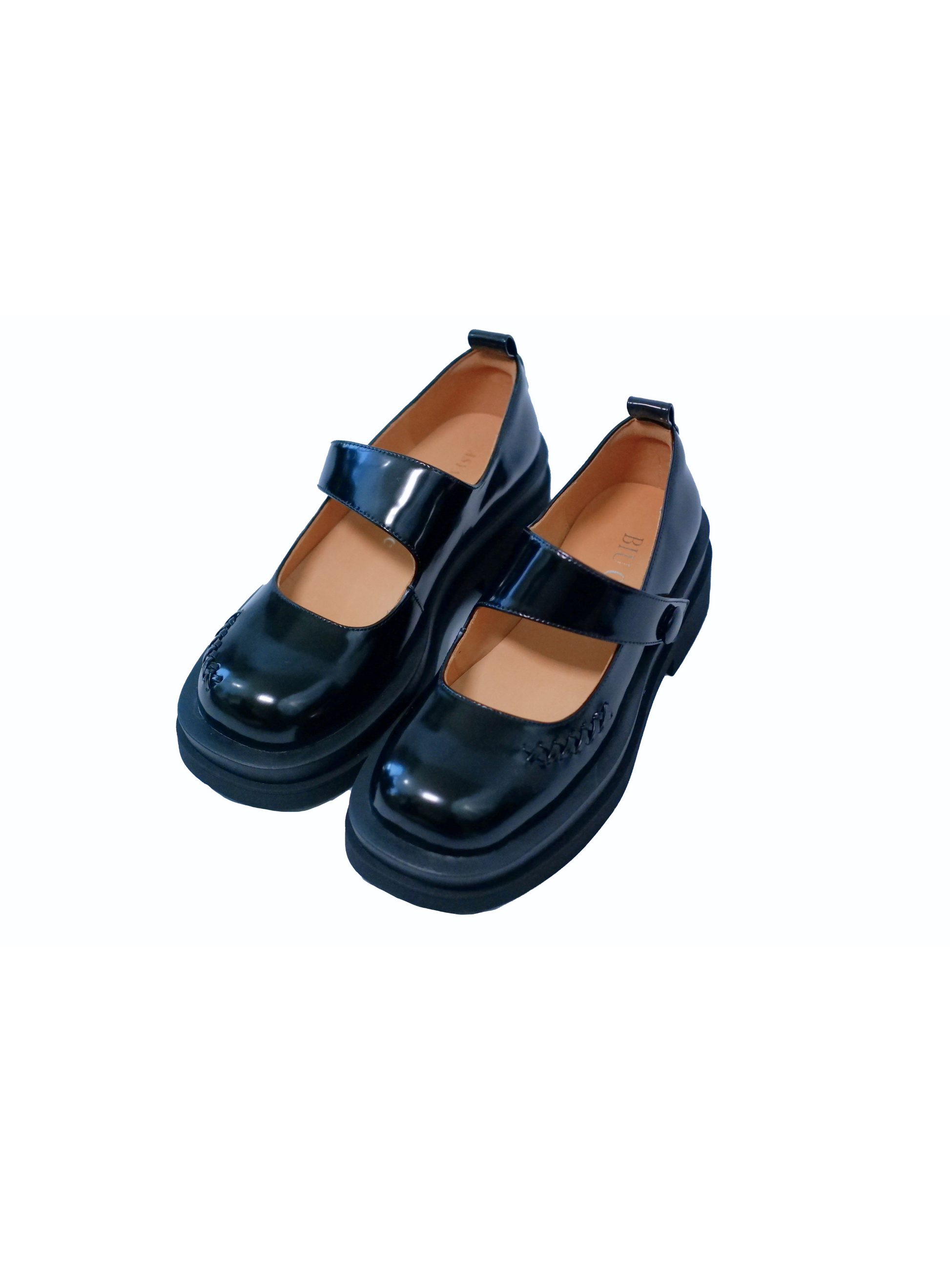 Showing the upper side view of a shiny-finish black platform Mary Jane shoes with wide strap and low block heel, with stitching details at the front side