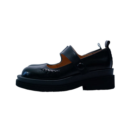Side view of a black platform Mary Jane shoes with wide strap and low block heel