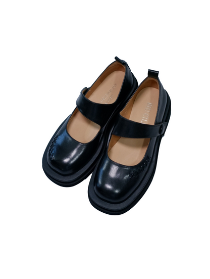 Black platform Mary Jane shoes with wide strap and low block heel with a matte finish