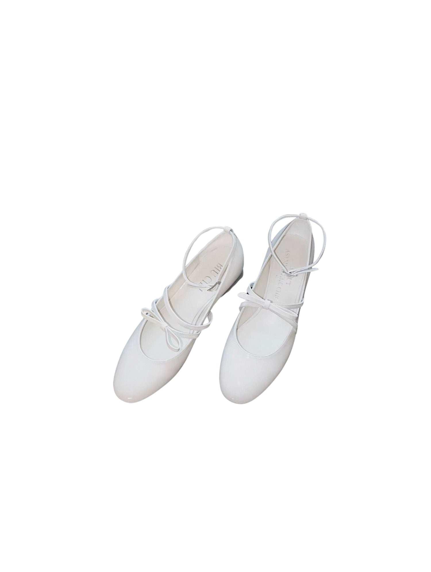 White patent leather Mary Jane heels with asymmetric bow straps