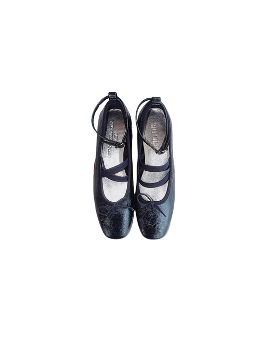 Navy metallic leather Mary Jane ballet flats with asymmetrical cross straps on a white background