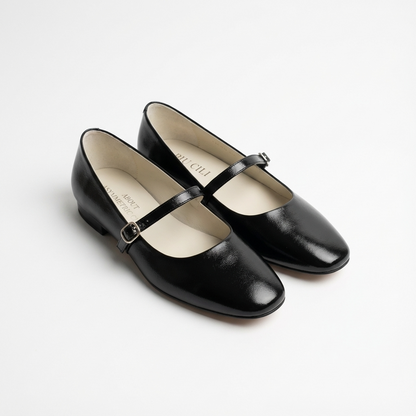 Pair of black shoes with a strap on a white background