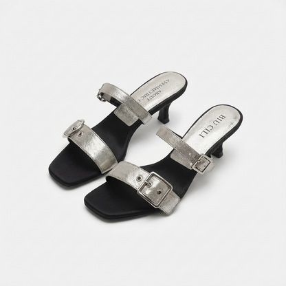 Pair of black and silver high-heeled sandals on a white background