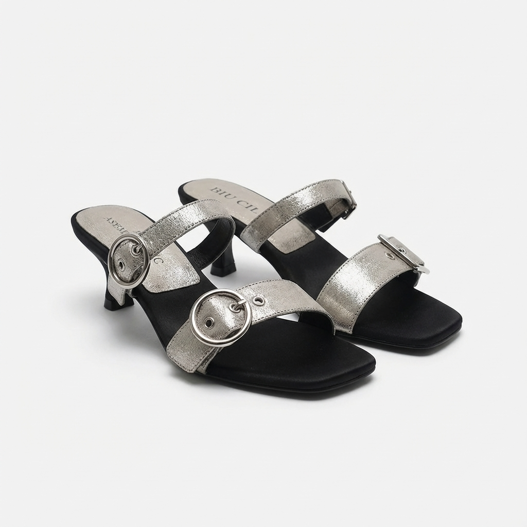 Pair of silver high-heeled sandals on a white background