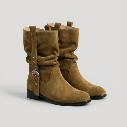 Pair of khaki suede boots on a light gray background